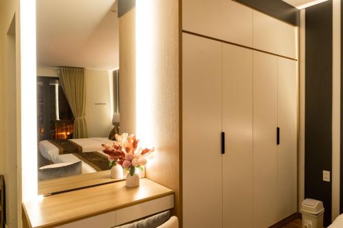 a bedroom with a bed and a mirror at The One Hotel in Hai Phong