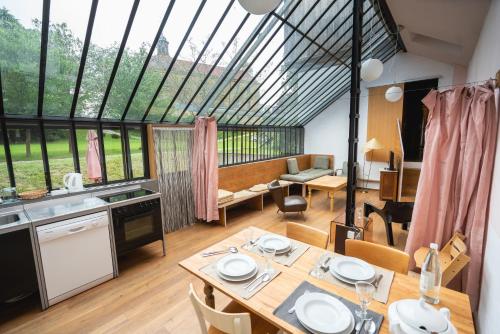 a kitchen and dining room with a large window at Gut Hornegg in Preding