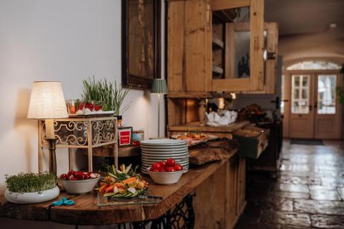 a kitchen with bowls of vegetables on a counter at Der Schlosswirt zu Anif - Biedermeierhotel und Restaurant in Anif