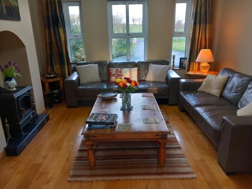 a living room with a couch and a coffee table at Inishmore Island B&B in Inishmore