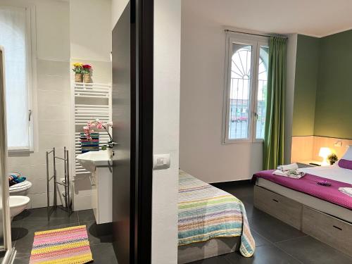 a bedroom with a bed and a bathroom with a sink at Bnbook Residence Matteotti in Novara