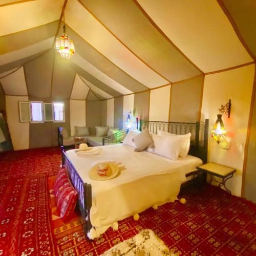 a bedroom with a large bed in a room at Merzouga heart camp in Merzouga