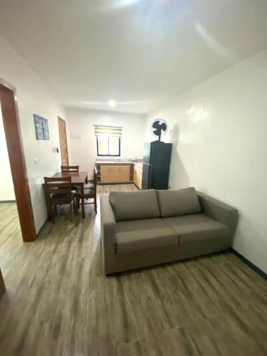a living room with a couch and a table at Hidden Lagoon Resort in Panglao