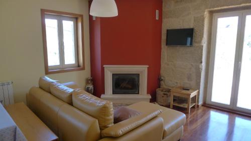 a living room with a couch and a fireplace at Villa Rio in Tangil