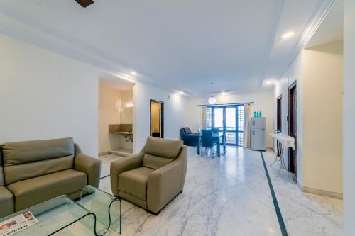 a living room with two couches and a table at Hotel Athome & Serviced Apartments by Deccan Serai Hotels in Hyderabad