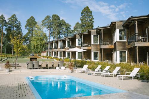 a house with a swimming pool in front of a building at Engeltofta Sea Lodge in Gävle