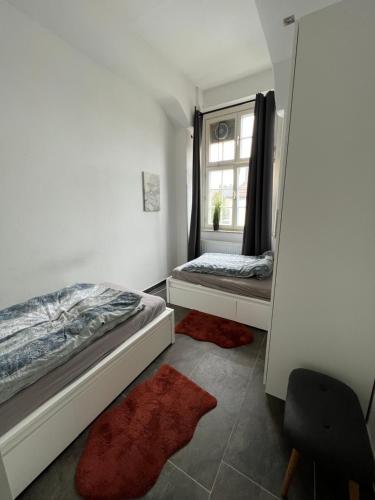 a bedroom with two beds and a window at Viersen Schöne Apartments am Dülkener Bahnhof Vi01 bis Vi09 in Viersen