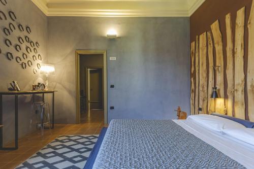 a bedroom with a large bed in a room at Antico Convento San Francesco in Bagnacavallo