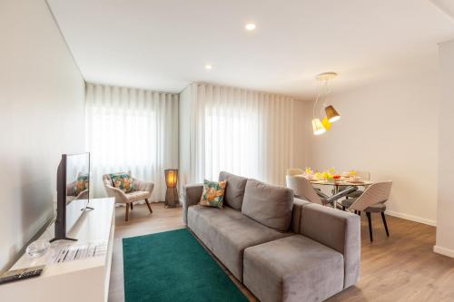 a living room with a couch and a table at Flamingo Apartment in City Center - Minho's Guest in Braga