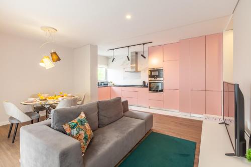 a living room with a couch and a table at Flamingo Apartment in City Center - Minho's Guest in Braga