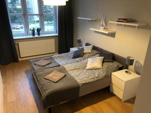 een slaapkamer met een bed met kussens erop bij Apartament BROWARNY in Ostrów Wielkopolski