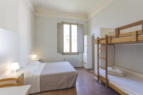a bedroom with a bed and a bunk bed at Antico Convento San Francesco in Bagnacavallo
