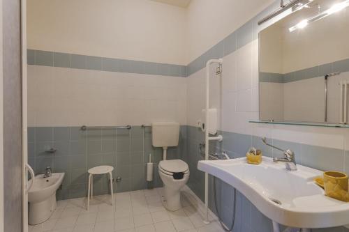 a bathroom with a sink and a toilet at Antico Convento San Francesco in Bagnacavallo