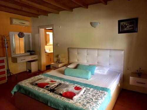 a bedroom with a large white bed with two pillows at Farm House in Kusadasi in Aydın
