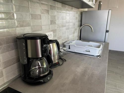 a coffee maker on a counter in a kitchen at Apartments Kostelic in Murter