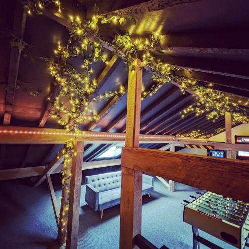 a room with a ceiling with christmas lights at The Eden Warehouse - Gold Apartment, sleeps 6 in Southport