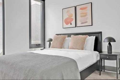 a white bedroom with a bed and a table at First Hill 1BR w Gym Coworking SEA-451 in Seattle