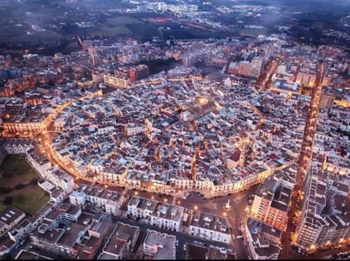 an aerial view of a large city at night at l'angolo di Gaudì, alcoba Fascinosa in Putignano