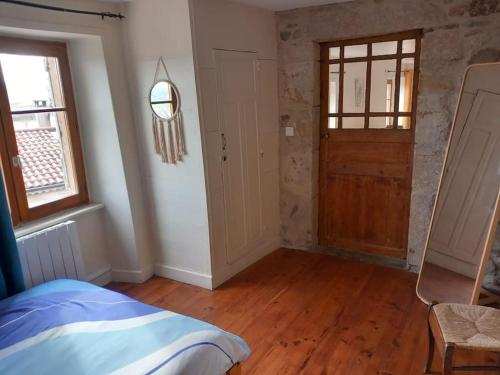 a room with a bed and a wooden floor at Joli appartement Les Archers in Montpeyroux
