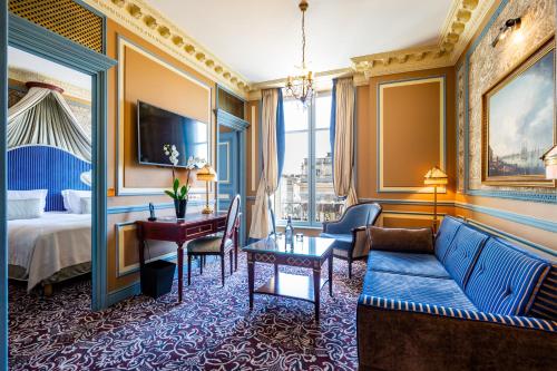 a hotel room with a bed and a couch at InterContinental Bordeaux Le Grand Hotel by IHG in Bordeaux