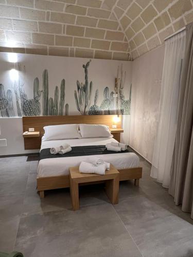 a bedroom with a bed with two towels on it at Egusa73 Favignana in Favignana