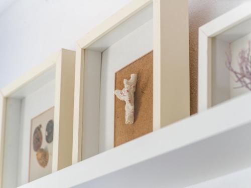 a bone on a shelf in a room with mirrors at Casa Lloc Tranquil in Cala Figuera