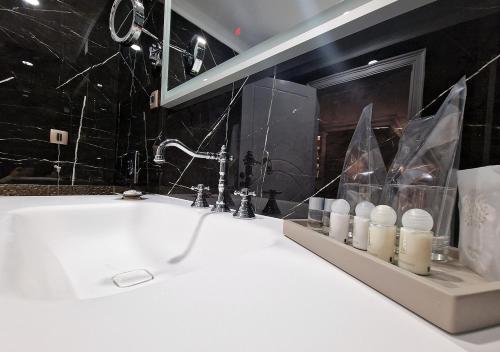 a bathroom with a white sink and a mirror at Boutique Hotel Bora & Villas Garamm in Pakoštane
