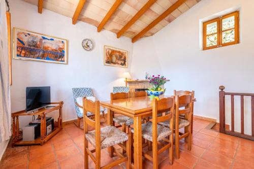 a dining room with a wooden table and chairs at Can Jaumins in Sóller
