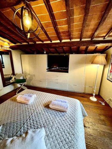 a bedroom with a large bed with two pillows on it at Pergaccio Deluxe House in Cortona