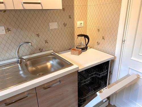A kitchen or kitchenette at Alghero Charming Apartments, Steps from the beach
