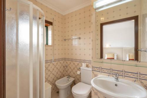 a bathroom with a white toilet and a sink at Hotel Padre Pio by Umbral in Fátima