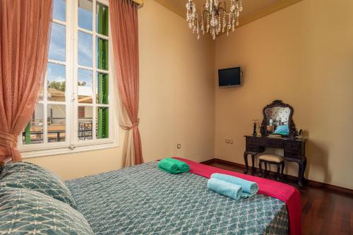 a bedroom with a bed with two pillows on it at Casa Centrale Kos in Kos