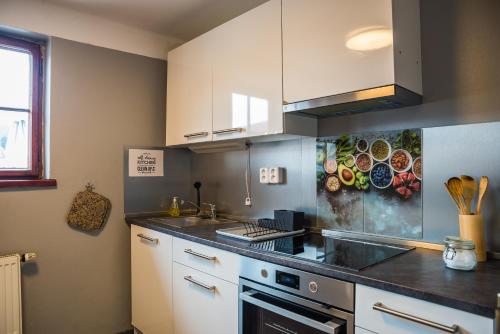 a kitchen with a sink and a stove top oven at Hostel Little Quarter in Prague