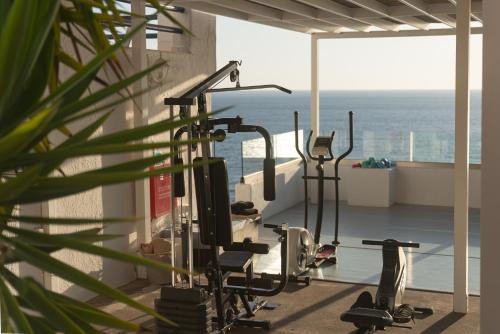 a gym with a view of the ocean at Karma Minoan in Agios Nikolaos