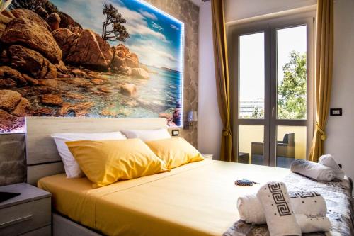 a bedroom with a large painting on the wall at Mar&Mar in Alghero