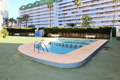 a swimming pool in front of a large building at Apolo 11 vistas al mar garaje y wifi in Calpe