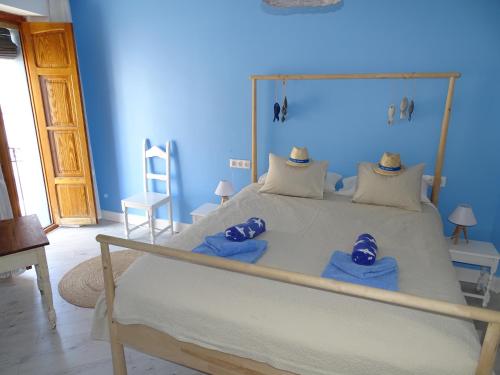 a bedroom with a large bed with blue walls at B&B Casa Ellie in Tormos