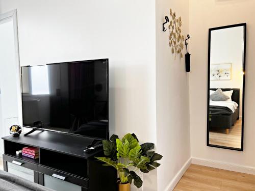 a living room with a large flat screen tv at Town Spot - Premium Studio - Sanador Victoriei in Bucharest