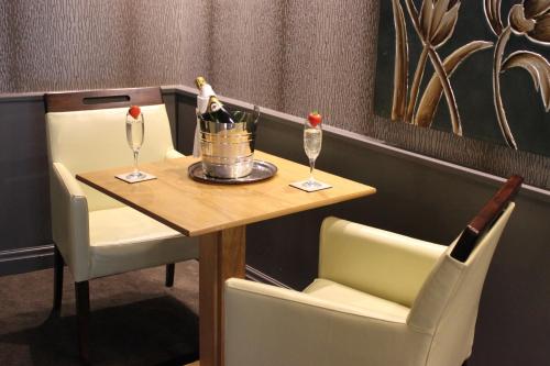 a table with two glasses and a bottle of champagne at MILL Hotel & Spa in Chester