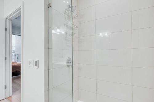 a white bathroom with a glass shower stall at South Lake Union 2br w gym roof nr restaurants SEA-554 in Seattle