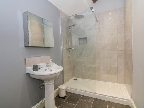a bathroom with a sink and a shower at Swallows Return in Macclesfield
