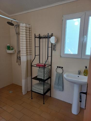 a bathroom with a black towel rack next to a sink at Quinta Do Cano in Évora