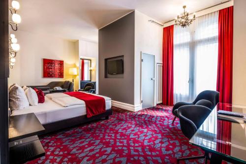 a hotel room with a bed and a red carpet at Scandic Palace Hotel in Copenhagen