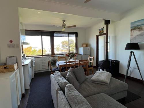 a living room with a couch and a table at Moana Beach Sunset Holiday Accommodation B in Moana
