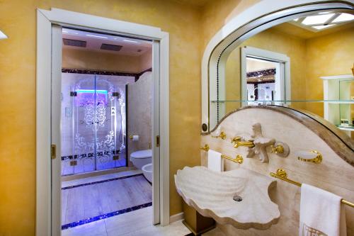 a bathroom with a sink and a mirror at Vip's Motel Luxury Accommodation & Spa in Lonato del Garda