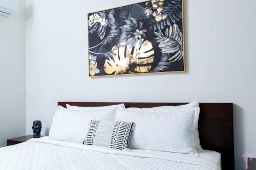 a bedroom with a bed with a picture on the wall at Villa Blue Amber Cabarete in Cabarete