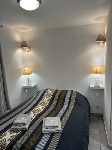 a bedroom with a bed with two towels on it at Maureillas - appartement 2 personnes - classé in Maureillas