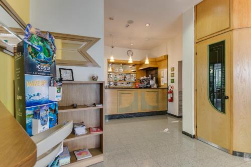a lobby of a store with a counter and a hallway at Hotel Villa Merope in Rimini
