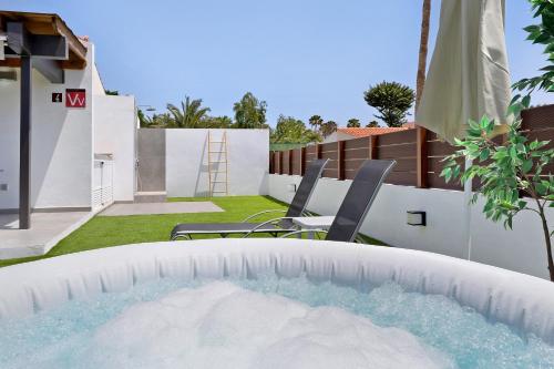 a swimming pool in the backyard of a house at Casa Luna Kingbed and Jacuzzi in Maspalomas