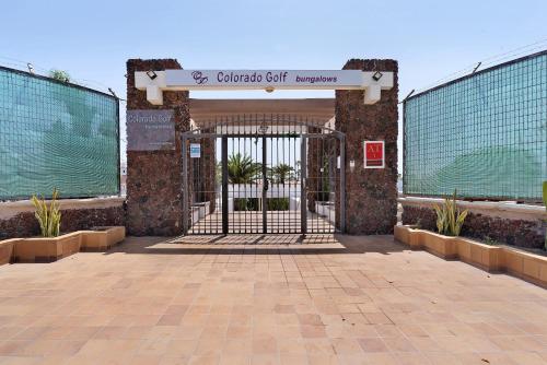a gate to a building with a sign on it at Casa Luna Kingbed and Jacuzzi in Maspalomas